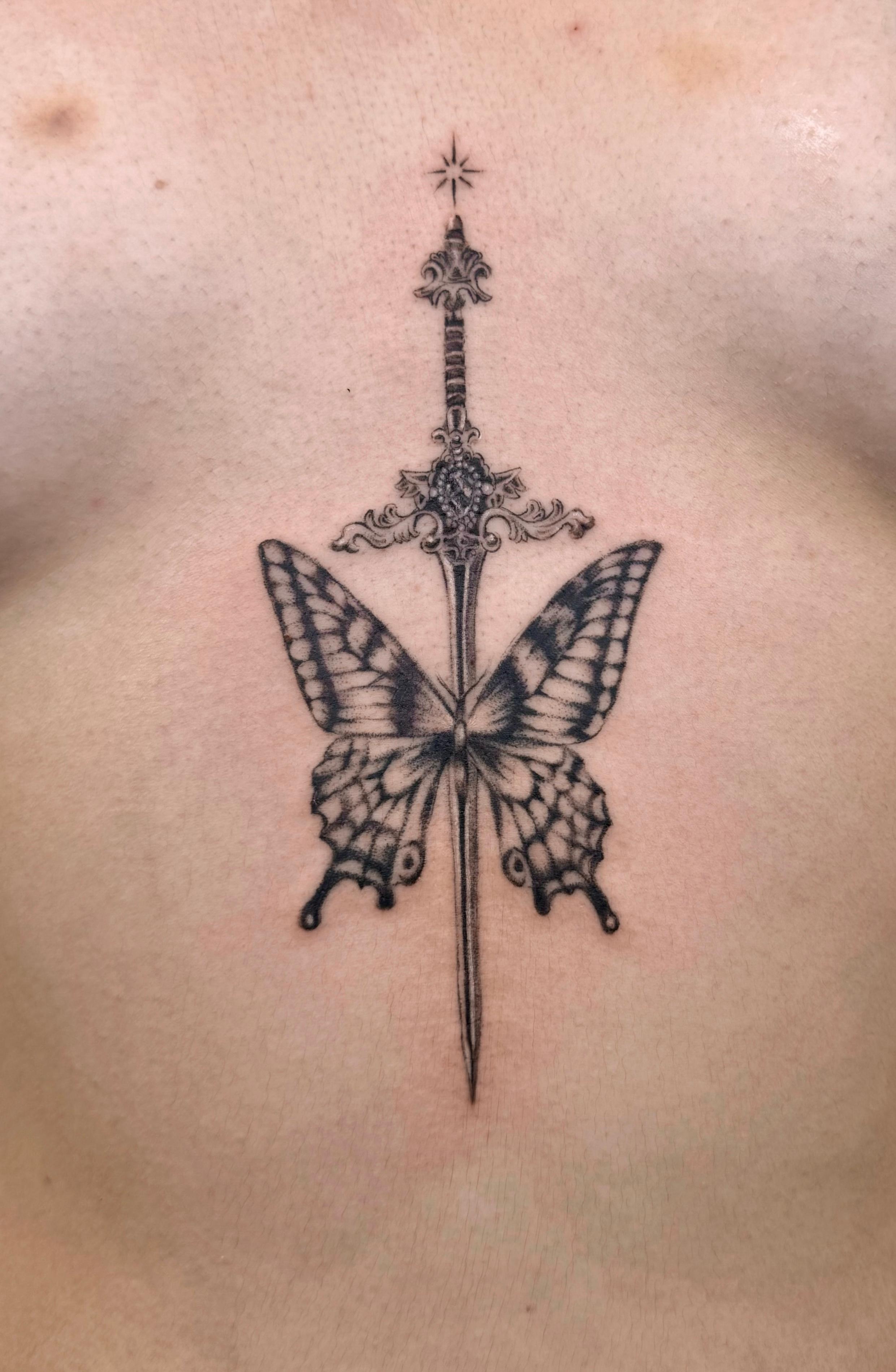 Black and grey butterfly and dagger tattoo