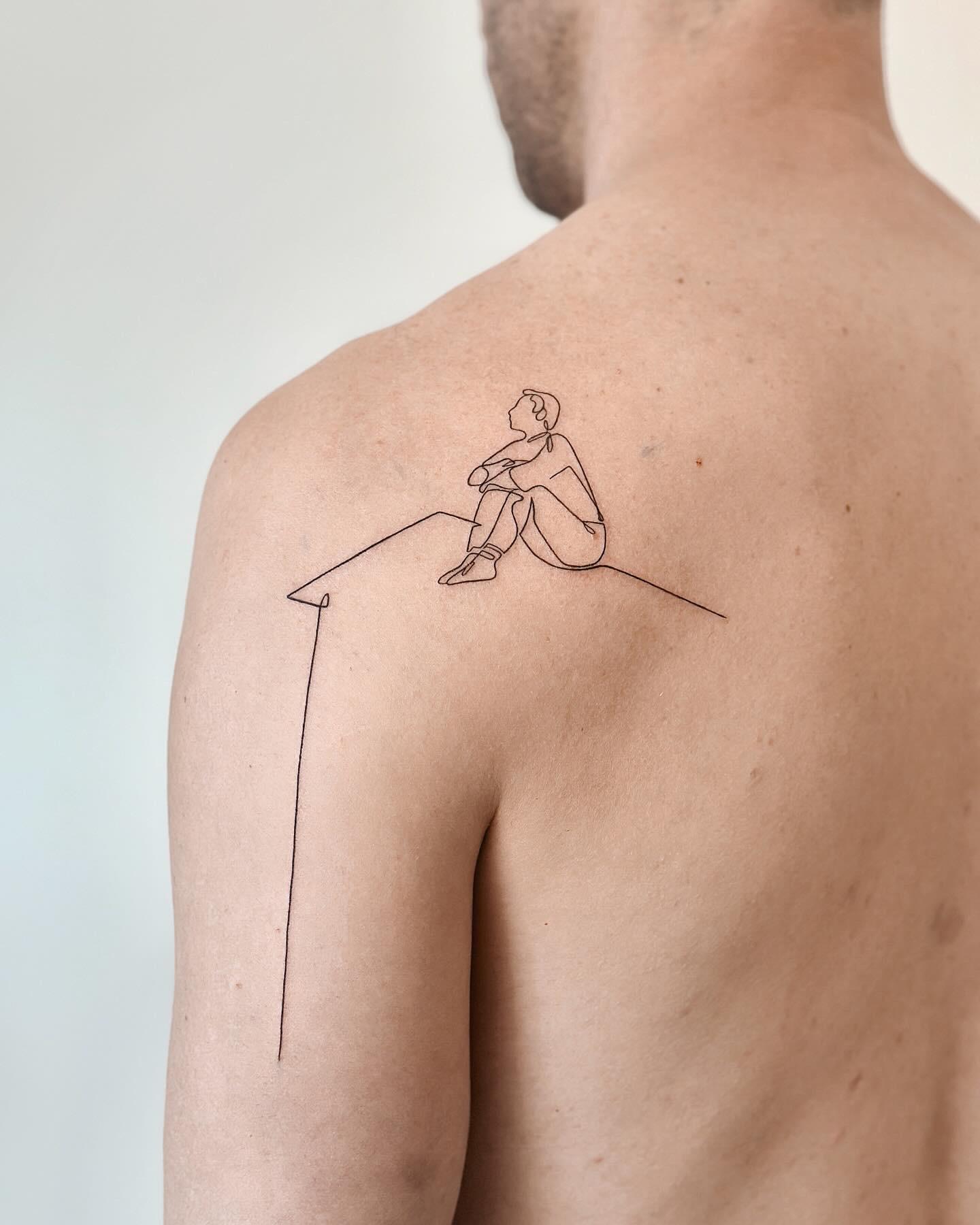 Fine line seated figure tattoo